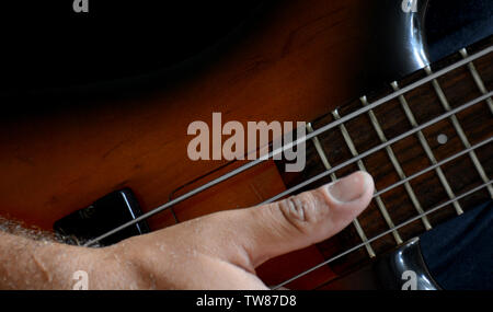 4 Strings vitange E-Bass Gitarre mit Händen spielen und anderen Perspektive Stockfoto