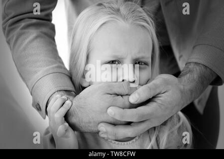 Mann für die kleinen Mädchen Mund. Kindesmissbrauch Konzept Stockfoto