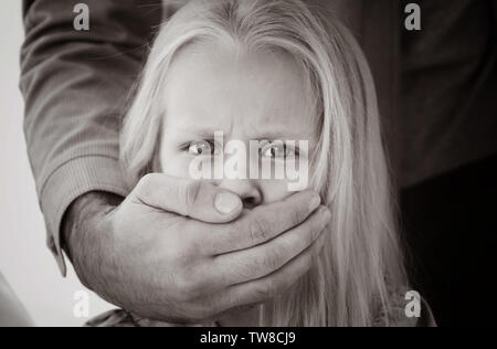 Mann für die kleinen Mädchen Mund. Kindesmissbrauch Konzept Stockfoto