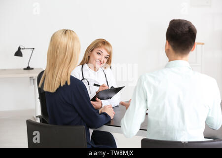 Ärztin consulting junges Paar in der Klinik Stockfoto