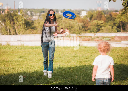 Familie Frisbee spielen auf der Wiese im Park Stockfoto