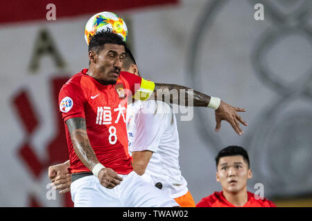 Brasilianische Fußballspieler Paulinho, top, der von China Guangzhou Evergrande Taobao F.C. leitet den Ball gegen einen Spieler von China Shandong Luneng Taishan F.C. in der achten - Finale der AFC Champions League 2019 in der Stadt Guangzhou, Provinz Guangdong im Süden Chinas, 18. Juni 2019. Dank der glücklichen Yang Sugs One des Gewinners, Guangzhou Evergrande beat Shandong Luneng 2-1 Im Hinspiel der AFC Champions League K.o.-Runde 1 hier am Dienstag. Stockfoto