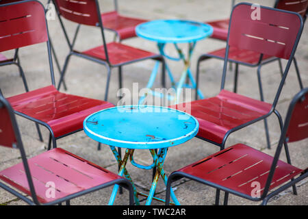 Metall Blau und Rot cafe Stühle und runde Tische Stockfoto