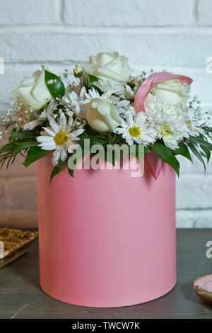 Weiße und gelbe Blume rosa runde Bouquet. Blumenarrangement in einen Hut, einen Topf mit Rosa für ein Mädchen auf ein Geschenk mit Rosen. Stockfoto