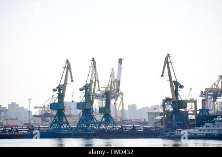 Hafenkräne industrielle Ansicht mit Wasser im Vordergrund. Stockfoto