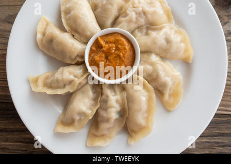 Platte der Nepalesischen Huhn momos und seine achar (Soße) Stockfoto