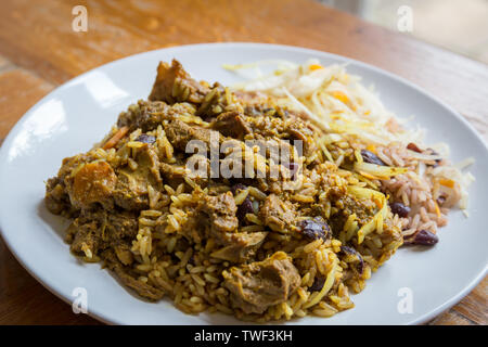 Die jamaikanische Essen. Jamaican Curry Goat serviert mit Reis und Erbsen Stockfoto