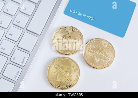 Bitcoin Währung Münze auf eine Kreditkarte. Währungen exchange Konzept auf einem weißen Holz- Desktop, Ansicht von oben und der leere Raum für Editor's Text. Stockfoto