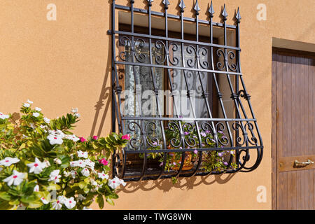 Vorderansicht eines gemütlichen Fenster mit Wachen und Sicherheit Bars auf Haus Wand Stockfoto