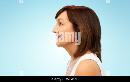 Profil von lächelnden älteren Frau über Weiß Stockfoto