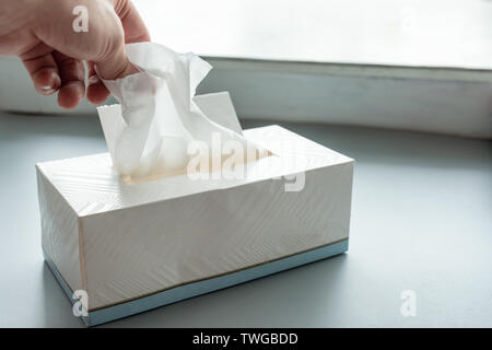 Von Hand gepflückt weisse Gewebe Papier aus der Verpackung, Stockfoto