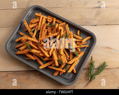 Süßkartoffel frites auf ein Backblech von oben mit weichem Fenster Beleuchtung Stockfoto