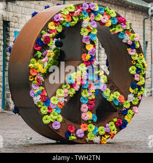 Peace Sign Skulptur mit Blumen in der Distillery District, Toronto, Ontario, Kanada. Stockfoto