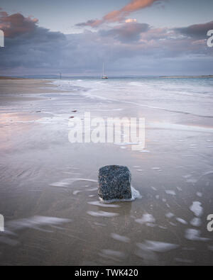 Sonnenuntergang Sturm Wolken reflektieren auf nassem Sand am Strand Stockfoto