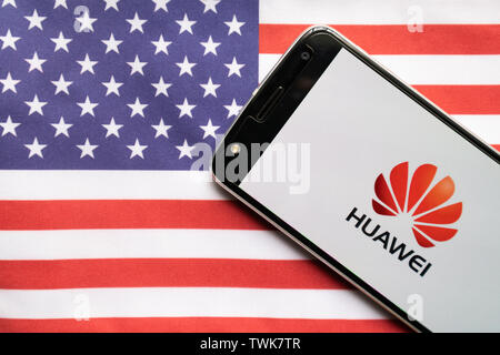 Maski, Indien - 21. Juni 2019: Huawei-Logo auf dem Bildschirm des mobilen auf US-Flagge. Stockfoto