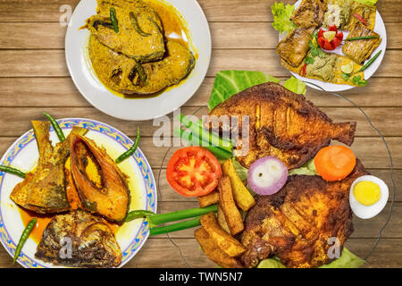 Indische Fisch essen (Küche) Gerichte auf Anzeige bestehend aus Frittierten butterfische Fisch mit rohu Fisch und hilsa Fisch Curry Stockfoto