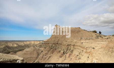 Ein einsamer Mann sitzt auf einem Mesa oder Butte in den Badlands von South Dakota. Stockfoto