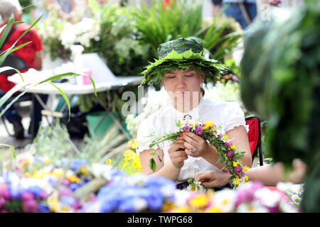 Riga, Lettland. Juni, 2019 21. Eine Frau macht Blume Kronen während der Midsummer festival Ligo Markt in Riga, Lettland, 21. Juni 2019. Die jährlichen Mittsommer festival Ligo Markt eröffnet hier am Freitag, während die Bauern und Handwerker aus ganz Lettland verkaufen Spezialitäten wie ländlichen Brot, Käse, Tee, Honig, hausgemachte Kuchen und chaplets. Credit: Edijs Palens/Xinhua/Alamy leben Nachrichten Stockfoto