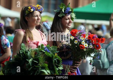 Riga, Lettland. Juni, 2019 21. Die Frauen, die Blume Kronen sind während der Midsummer festival Ligo Markt in Riga, Lettland, 21. Juni 2019 gesehen. Die jährlichen Mittsommer festival Ligo Markt eröffnet hier am Freitag, während die Bauern und Handwerker aus ganz Lettland verkaufen Spezialitäten wie ländlichen Brot, Käse, Tee, Honig, hausgemachte Kuchen und chaplets. Credit: Edijs Palens/Xinhua/Alamy leben Nachrichten Stockfoto