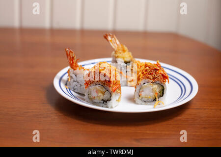 Scheiben von crunchy Dragon roll Sushi mit Shrimp Tempura auf einen Servierteller Stockfoto