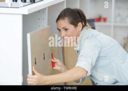 Junge Frau mit elektrischer Schraubendreher installation Stockfoto