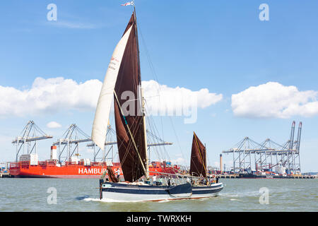 Thames Estuary, Vereinigtes Königreich. 22. Juni, 2019. Traditionelle cargo Barge Edith Mai übergibt die moderne Container Terminal in London Gateway historischen segeln Lastkähne in der 88. Ausgabe des Thames Sailing Barge Match in der Themsemündung übernommen haben, beendete bei Gravesend, Kent. Die Flotte der 10 Lastkähne für das erste Mal eine brandneue Sailing Barge Blue Mermaid, Cargo und Auszubildende, die Gewinnen meer Zeit zum Erlernen der traditionellen Seemannschaft Kenntnisse zu tragen. Rob Powell/Alamy leben Nachrichten Stockfoto