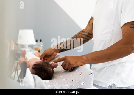 Neugeborenes Baby grabbing's Vater Finger auf Wickeltisch Stockfoto