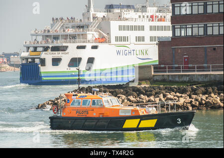 Portsmouth, Großbritannien - 1 April, 2019: wightlink Fähren und Pilot Tauziehen in der historischen Naval Dockyard Hafen von Portsmouth, Großbritannien Stockfoto