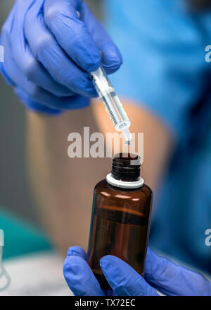 Krankenschwester versorgt dropper Medikation in einem Krankenhaus, konzeptionelle Bild Stockfoto