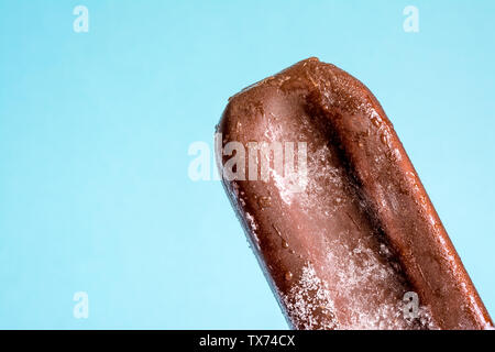 Eis am Stiel in Schokolade Glasur close-up mit Kondensat und Eisbildung Frost im Sommer und blauer Himmel. Stockfoto