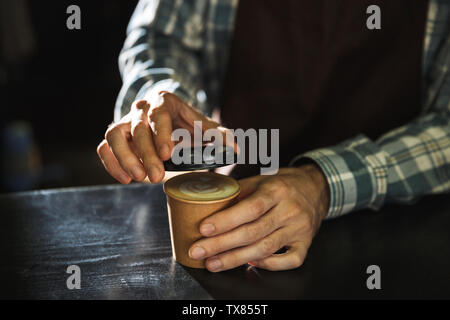 Zugeschnittenes Bild der modernen Barista junge tragen Schürze Kaffee im Cafe oder Kaffeehaus Arbeiten im Freien Stockfoto