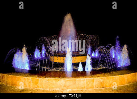 Am Brunnen der Stadt, können Sie Ruhe und Entspannung, während an der neuen Formen des Wasserstrahls. Multimedia Bunte Brunnen bei Nacht. Stockfoto