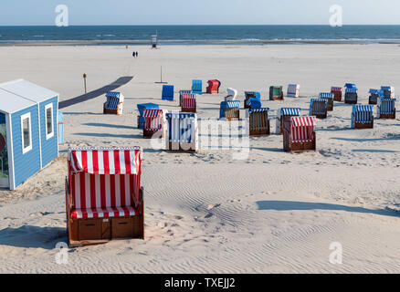 Weg zum weissen Strand mit bunten Liegestühle auf der friesischen Insel Juist. Stockfoto