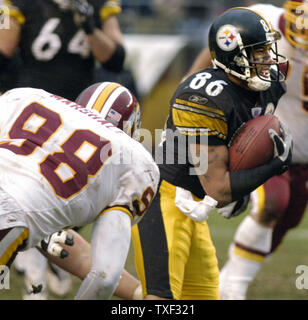 Pittsburgh Steelers Hines Ward nimmt eine Ben Roethlisberger Pass und gewinnt 15 Yards vor der Washington Redskins Lemar Marshall auf dem Angriff im vierten Quartal die Steelers 16 zu 7 Am 28. November gewinnen, 2004 am Heinz Feld in Pittsburgh, Pennsylvania verbindet. (UPI Foto/Archie Carpenter) Stockfoto