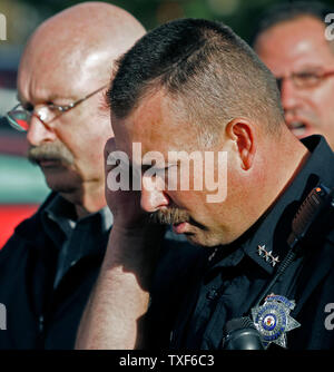 Park County Sheriff Fred Wegener (C) mit gesenktem Kopf spricht in einer gebrochenen Stimme das Ende der Geiselnahme an der Platte Canyon High School in Bailey zu verkünden, Colorado, 27. September 2006. Eine bewaffnete eingegeben Platte Canyon High School, feuerte Schüsse, dauerte sechs Geiseln, dann vier Geiseln frei. Park County Sheriff Department deklariert eine taktische Situation mit dem Ergebnis der ein Student erschossen und die bewaffneten sich selbst töten. Polizeichef Wegener kannte die Geisel, die geschossen wurde und starb später in einem Denver Krankenhaus von einem Schuss in den Kopf. (UPI Foto/Gary C. Caskey) Stockfoto