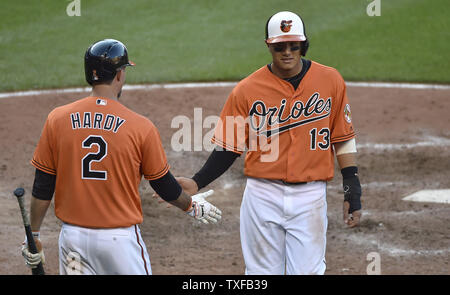 Baltimore Orioles "Manny Machado (13) gratuliert durch Mannschaftskameraden J.J. Hardy nach dem Scoring das Gewinnen laufen gegen die Los Angeles Angels während des achten Inning in Camden Yards, Baltimore, 9. Juli 2016. Baltimore gewann 3-2. Foto von David Tulis/UPI Stockfoto