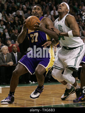 Los Angeles Lakers forward Ron Artest, left, with hair dyed blonde and  purple letters in three different languages, greets Orlando Magic center  Dwight Howard prior to the start of an NBA basketball