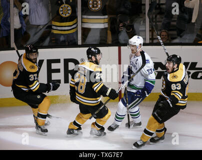 Boston Bruins center Brad Marchand (63) feiert sein Ziel mit Mannschaftskameraden winger nach Mark Recchi (28) und center Patrice Bergeron (37) Vancouver Canucks center Henrik Sedin (33) Skates durch die in der ersten Periode von Spiel 6 des Stanley Cup Finale bei TD Garden in Boston, Massachusetts am 13. Juni 2011. UPI/Matthew Healey Stockfoto