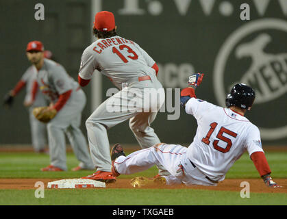 Boston Red Sox Dustin Pedroia Folien in die zweite mit einem Doppelbett als St. Louis Cardinals2B Matt Carpenter nimmt die im vierten Inning von Spiel 2 der World Series werfen am Fenway Park in Boston am 24. Oktober 2013. UPI/Kevin Dietsch Stockfoto