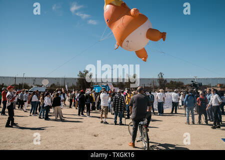 Ein Baby blimp von Präsident Trump schwebt über Demonstranten bei einer Anti-Trumpf-Rallye in Calexico, Kalifornien am 5. April 2019. Präsident Trump besucht die Grenze auf einem Abschnitt der Austausch Fechten zu schauen, ein 30 Fuß Barriere. Foto von Ariana Drehsler/UPI Stockfoto