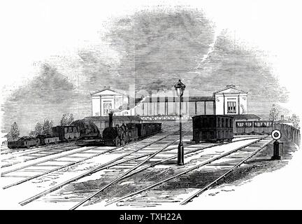 Swindon Station auf der Great Western Railway, 1845. Isambard Kingdom Brunel (1806-1859) bevorzugt Breitspur 7 ft 1/4 Zoll (2,2 m) und den großen Westerrn Bahn entwickelt sich entsprechend. Jedoch in das Messgerät Act von 1846 erklärt, dass alle künftigen Bahnstrecke der Standard 4 Fuß 8 1/2 Zoll (1,44 m) Manometer eingeführt von George Stephenson (1781-1848) auf der Liverpool and Manchester Railway werden sollte. Es war nicht bis 1892, dass die letzten Breitspur Track angehoben wurde. Von der "Illustrated London News". (London, 18. Oktober 1845). Stockfoto