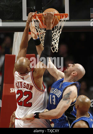 Chicago Bulls vorwärts Taj Gibson (L) dunks über Orlando Magic center Marcin Gortat im zweiten Quartal in der vereinigten Mitte in Chicago am 2. Januar 2010. UPI/Brian Kersey Stockfoto