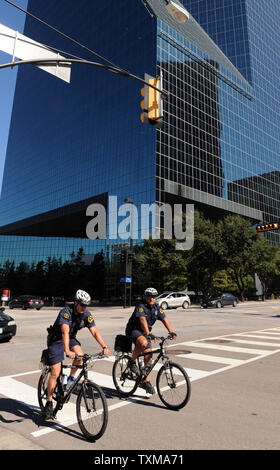 Polizisten Fahrrad hinter dem Brunnen Ort Gebäude in Dallas, Texas, am 25. September 2009. Laut FBI, jordanische Staatsbürger Hosam Maher Husein Smadi ein Fahrzeug beladen mit Regierung geparkt - gefälschte Sprengstoff in der Tiefgarage des 60-stöckigen Turm im Zentrum von Dallas. Smadi die Festnahme gestern war Teil eines FBI sting Operation, nachdem ein Agent die Überwachung eines on-line-extremistischen Website Smadi Luxemburg-gipfels Jihad gegen die USA mehr als vor sechs Monaten entdeckte, begann. UPI/Ian Halperin Stockfoto