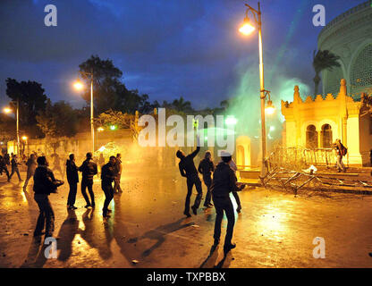 Ägyptische Demonstranten werfen Steine auf den Präsidentenpalast in Kairo in Ägypten, am 1. Februar 2013, als die Menschen auf die Straßen über dem Land in eine Show der Opposition gegen Mursi und seinen Muslimischen Bruderschaft regierende Partei nahm. Ägyptische Sicherheit verwendet, Wasserwerfer und schossen in die Luft, als die Demonstranten Benzinbomben und Steine auf das Gelände des Präsidentenpalastes warf, sagte ein Sprecher des Präsidenten. UPI/Ahmed Jomaa Stockfoto