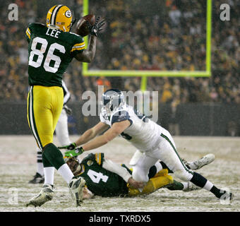 Green Bay Packers Quarterback Brett Favre (4) ist durch die Seattle Seahawks defensive nivellierten Angriff Craig Terrill (R) nach einem 11-Yard-Empfang zu festes Ende Donald Lee (86) Im zweiten Quartal des NFC Divisional Endspiel am Lambeau Field in Green Bay, Wisconsin am Januar, 12, 2008. Die Verpacker gewann 42-20. (UPI Foto/Brian Kersey) Stockfoto
