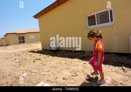 Ein israelischer Siedler Mädchen aus mohrungen im Gazastreifen, Wanderungen durch neue Mobile home in Nitzan, im Süden Israels, 1. August 2005. Die vorübergehende Unterbringung wird von der Regierung für die israelischen Siedler, die vor der bevorstehenden Rückzug aus dem Gazastreifen zu bewegen möchten. Der israelische Premierminister Ariel Sharon sagte, dass über die Hälfte der in Frage kommenden Bewohner des Gazastreifens ausgefüllt haben Anwendungen, eine Entschädigung vom Rückzug Behörde zu erhalten. (UPI Foto/Debbie Hill) Stockfoto