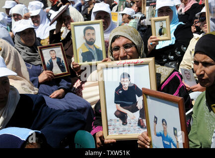 Palästinenser halten Fotos von Verwandten in israelischen Gefängnissen auf palästinensische Gefangene' Day bei Präsident Mahmoud Abbas' Hauptquartier in Ramallah, West Bank, 17. April 2008 statt. Präsident Mahmud Abbas sagt die Freilassung aller palästinensischen Gefangenen müssen Teil ein Friedensabkommen mit Israel. Mehr als 8.500 Palästinenser in israelischen Gefängnissen festgehalten. (UPI Foto/Debbie Hill) Stockfoto