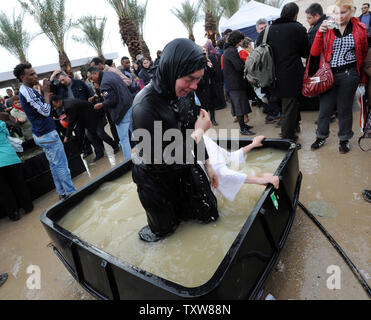 Ein Griechisch-orthodoxe Nonne tauft sich selbst in eine Wanne gefüllt mit Wasser aus dem Jordan bei Qasr el Yahud gepumpt, 18. Januar 2010. Hunderte von orthodoxen Christen auf das Fest der Erscheinung des Herrn an Der Qasr el Yahud versammelt - Taufstelle am Jordan in der Nähe der West Bank Stadt Jericho. Das Qasr el-Yahud taufstelle ist traditionell geglaubt, der Standort am Jordan, wo Johannes der Täufer Jesus Christus getauft zu werden. UPI/Debbie Hill Stockfoto