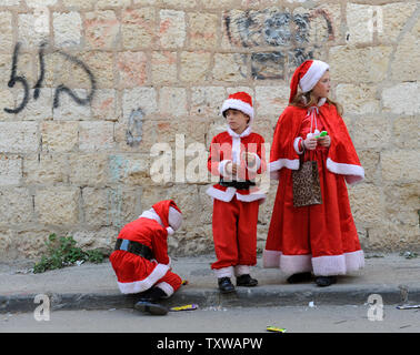 Ultra-orthodoxe jüdische Kinder tragen Santa Kostüme während der Feier die Purim Urlaub in Mea Shearim in Jerusalem, 21. März 2011. Der jüdische Feiertag Purim feiert die Rettung der Juden aus Völkermord im alten Persien, wie im Buch Esther erzählt. UPI/Debbie Hill Stockfoto