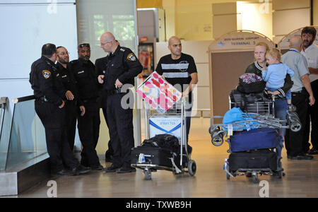 Reisende, die Israelische Polizei in Ben Gurion International Airport in der Nähe von Tel Aviv, in einem Vorgang zu stoppen pro-palästinensischen internationale Aktivisten in Israel, 8. Juli 2011. Mehr als 200 pro-palästinensischen Demonstranten versucht, Israel zu erreichen wurden an den Flughäfen in Europa gesperrt nach Israel ausländische Fluggesellschaften auf der schwarzen Liste gebeten, Reisende aus der Bordkarte Flüge zu stoppen. Die israelische Polizei nahm 30 Aktivisten, die in Israel UPI/Debbie Hill gelandet Stockfoto